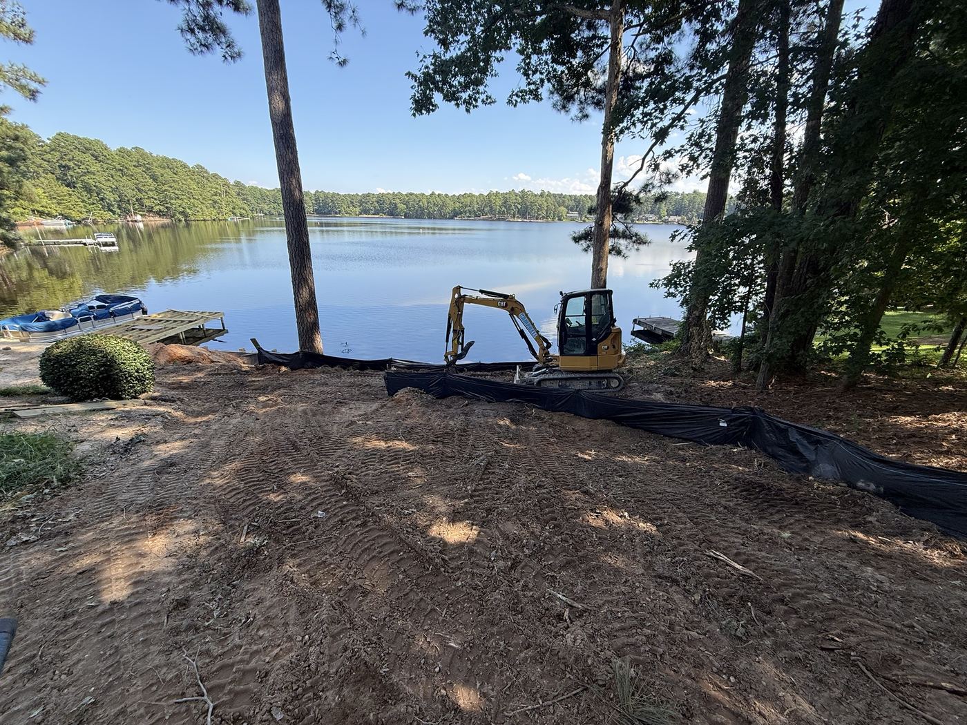 Graded lakefront lot with silt fence along the shoreline to keep soil out of the water.
